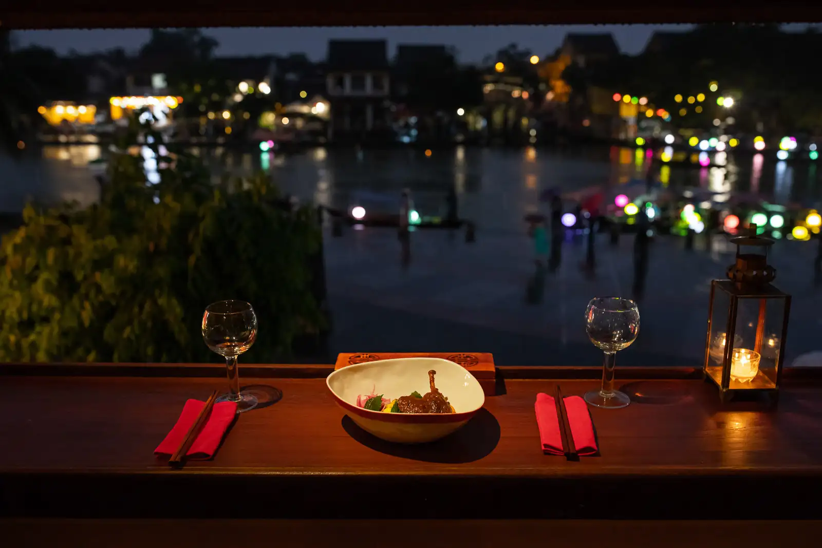 Have dinner at a riverbank restaurant in Hoi An