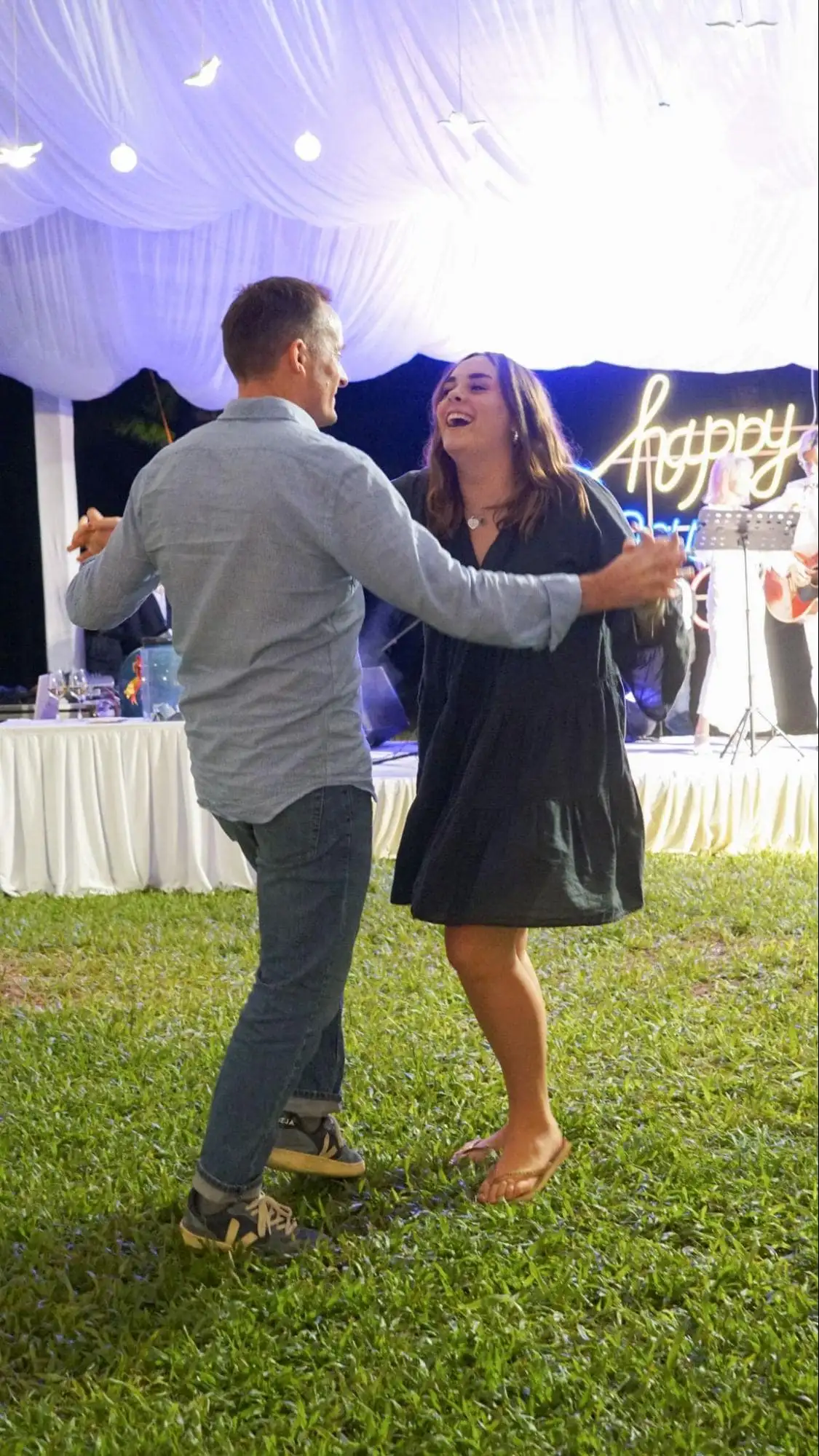 Tourists dance together under the lights