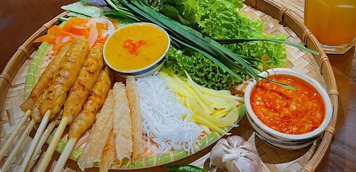 Smoky grilled pork sausage is paired with fresh herbs, rice paper and a rich dipping sauce