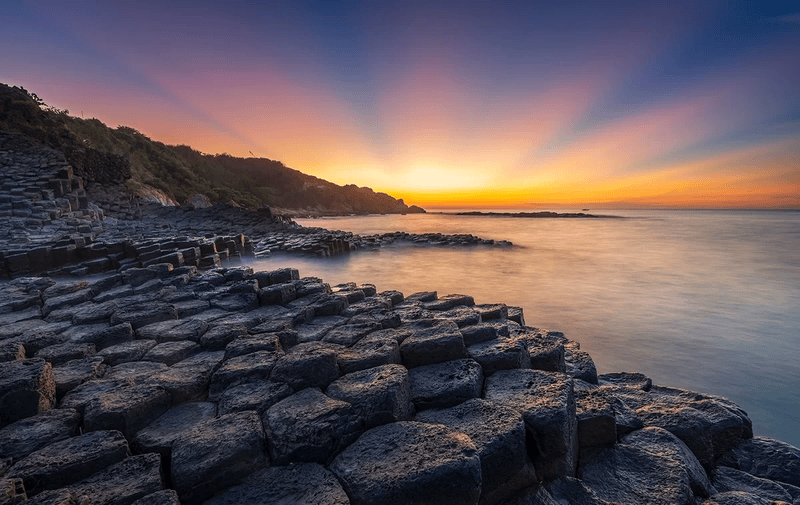 Golden sunrise over the stunning hexagonal rocks of ganh da dia (source: Vietskytour)