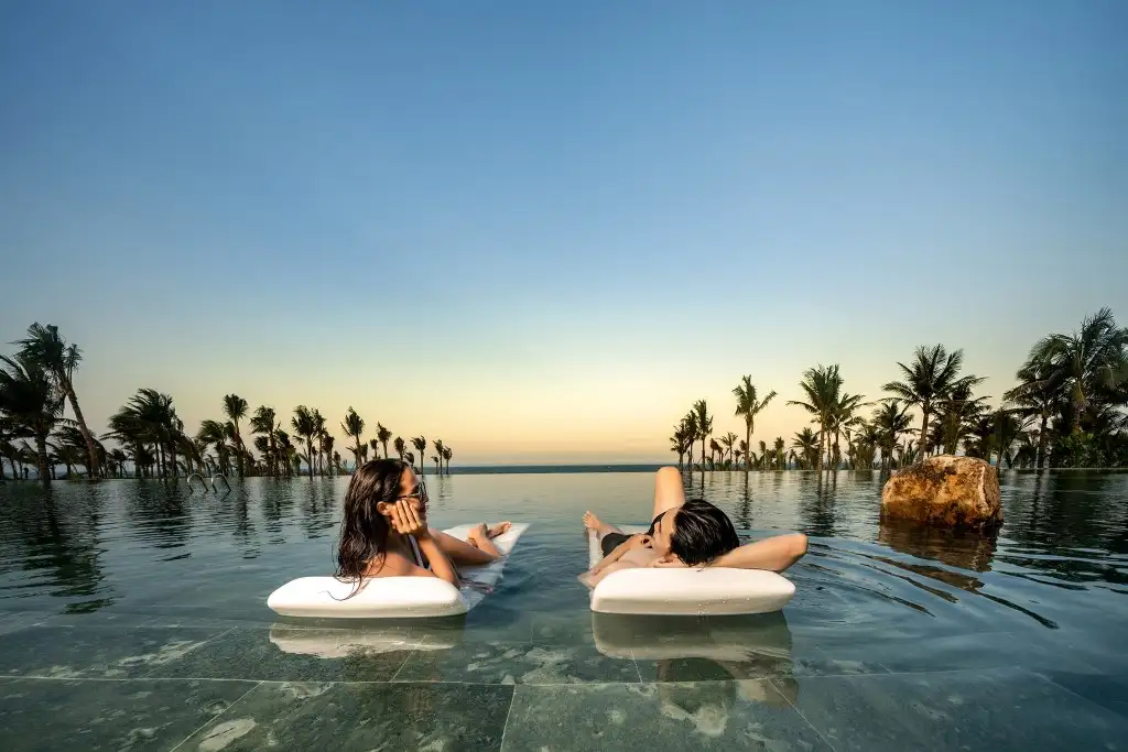 Post-run recovery at Bliss Hoi An's 55-meter infinity pool, longer than an Olympic pool and steps from the beach