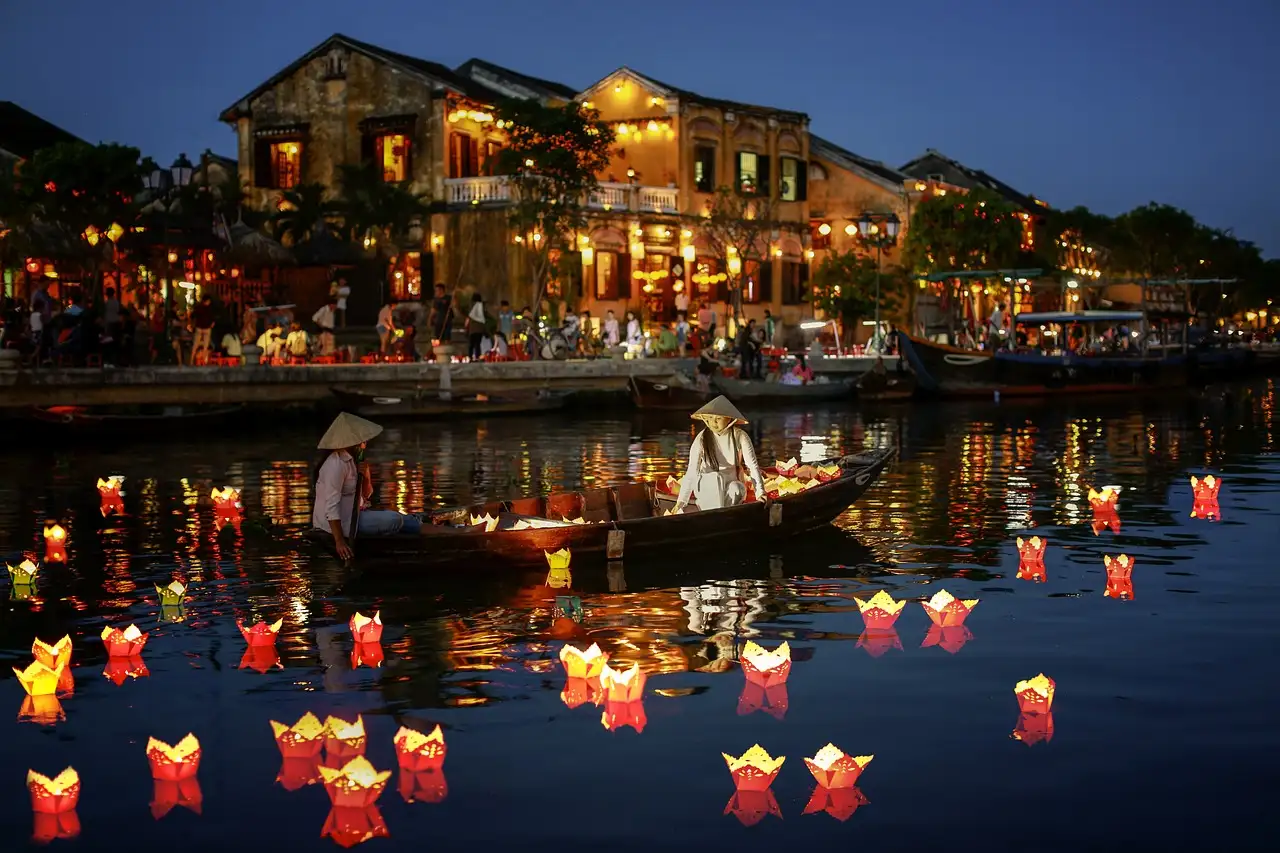 Hoi An Ancient Town lantern-lit street at night with vehicle restriction sign.