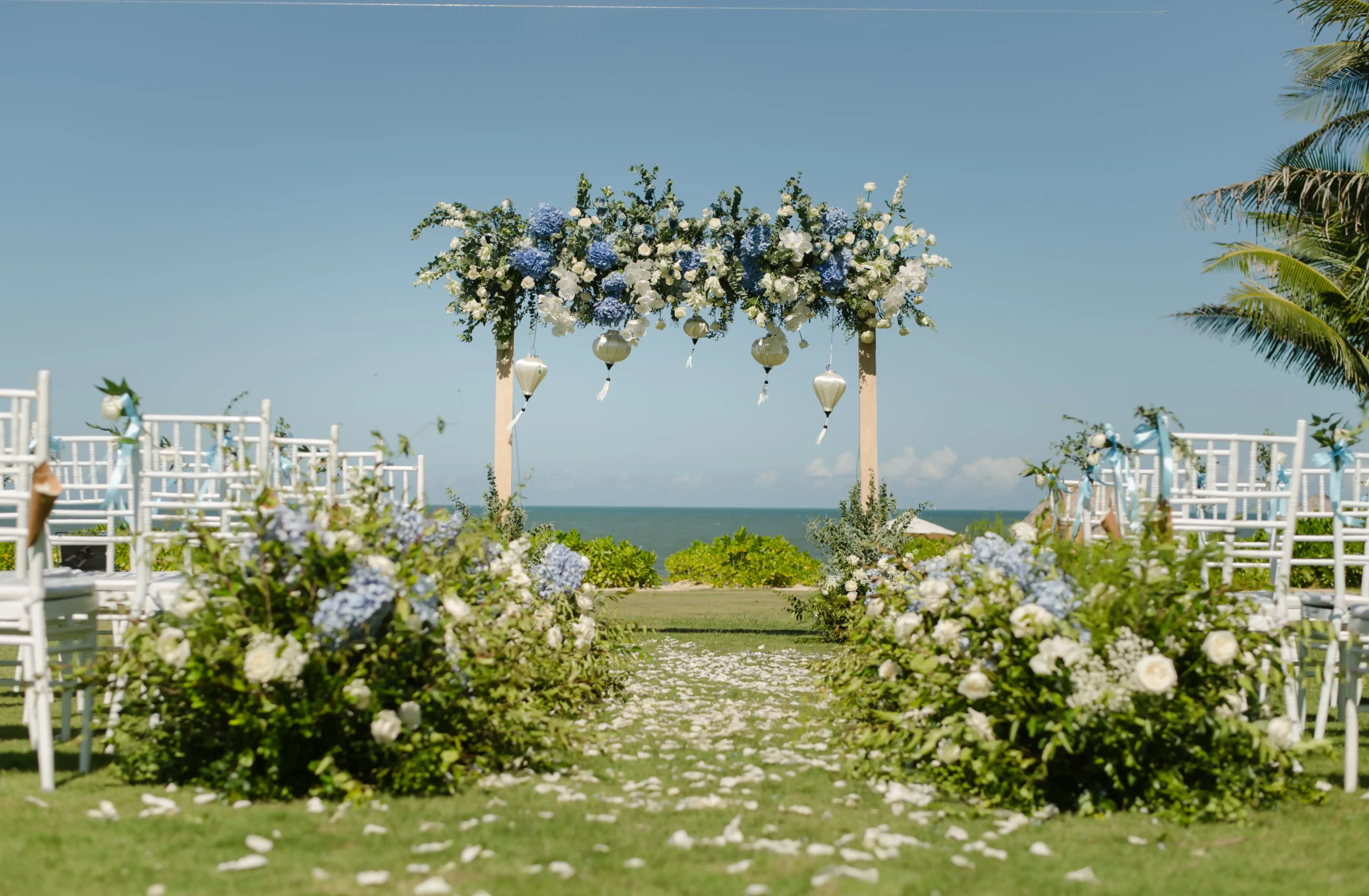 Blue and white floral arch facing the sea on the oceanfront lawn