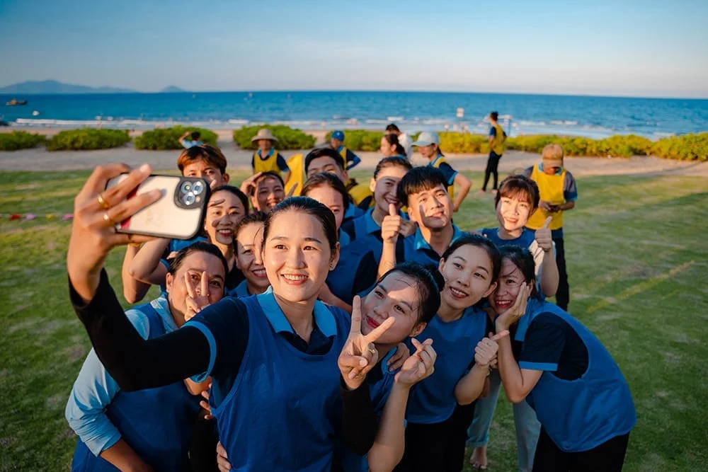 Group of employees participating in a beach team-building game in Hoi An