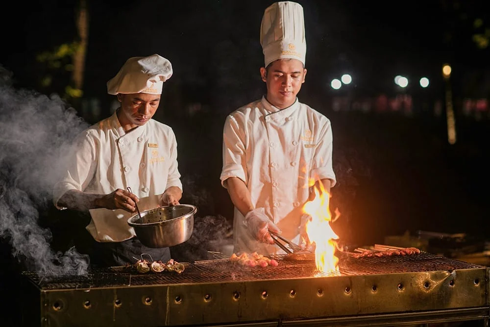 Beach BBQ setup with grilled seafood for a company evening event