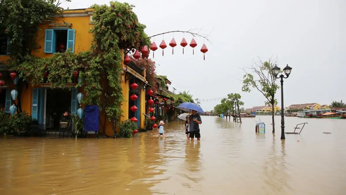 Flooded street in Hoi An during rainy season with locals walking through the water (Source: VnExpress International)
