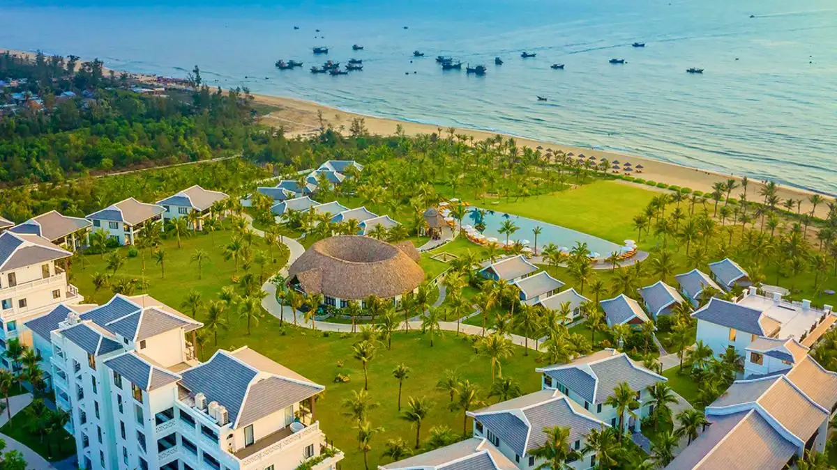 Bliss Hoi An Beach Resort & Wellness offers a quieter base away from the festival crowds