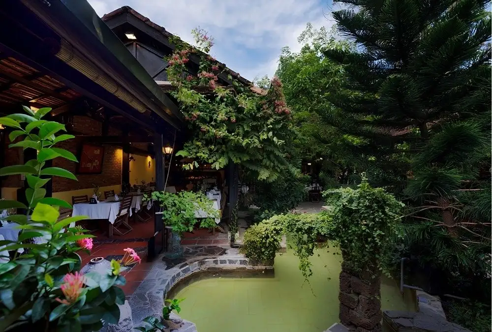 Skylights, high ceilings and garden courtyards can make spaces feel more open and less noisy (Source: secretgardenhoian.com)