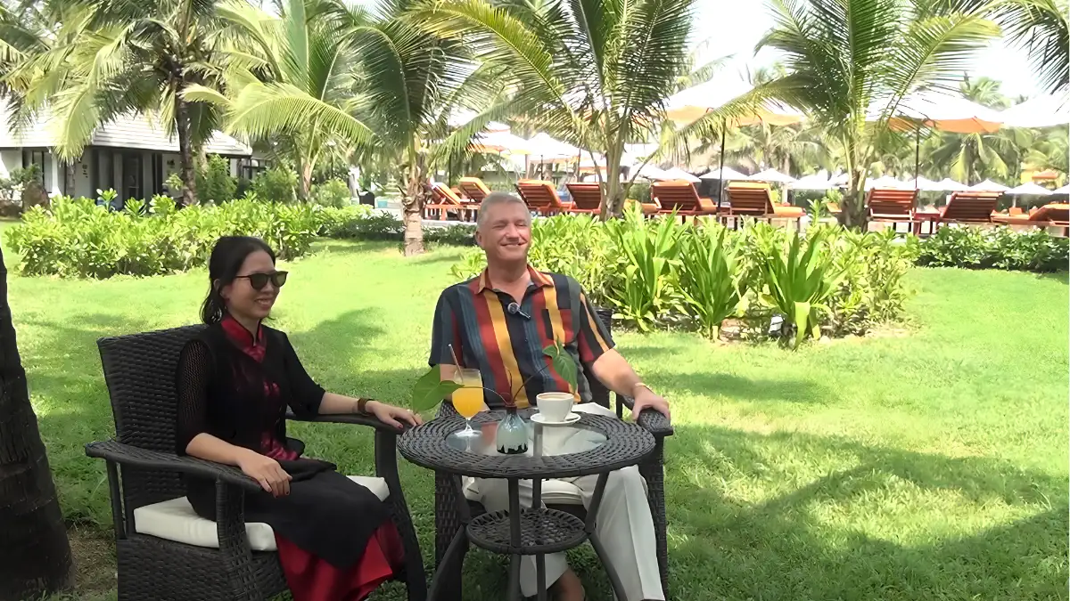 Guest enjoying a peaceful morning by the beach at Bliss Hoi An