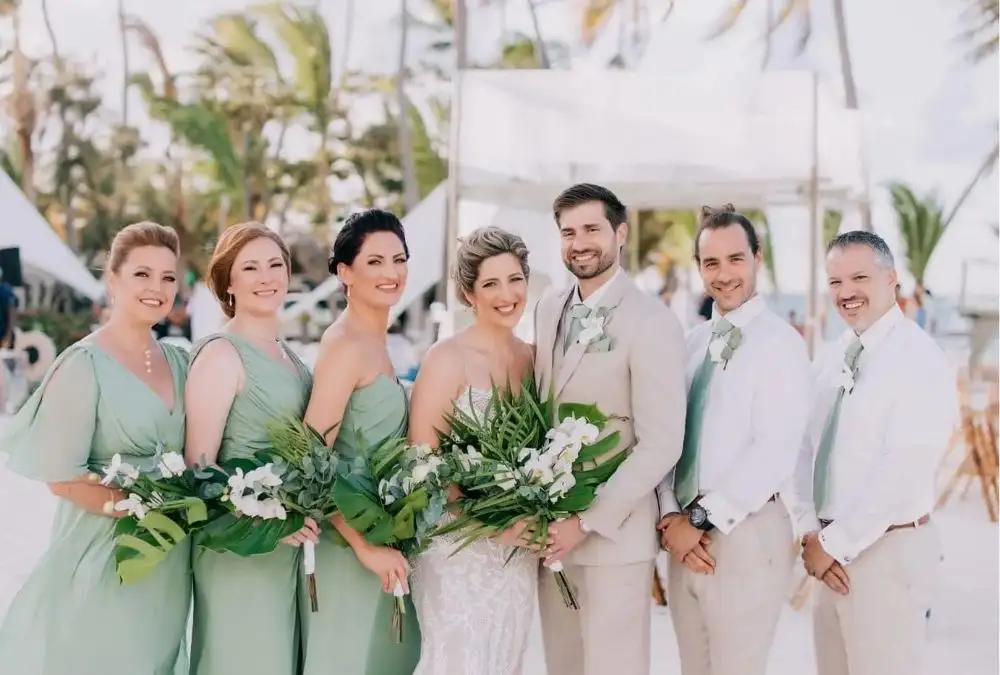 Guests in coordinated colours at an intimate beach wedding (Source: puntacanaphotographer.com)